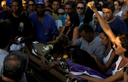 A relative reacts over the coffin of Rio de Janeiro's city councillor Marielle Franco, 38, who was shot dead, during her burial in Rio de Janeiro, Brazil March 15, 2018. REUTERS/Ricardo Moraes