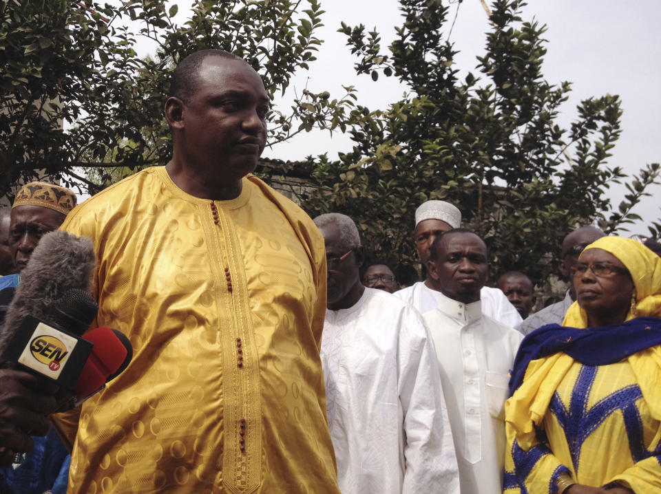 Gambia President-elect Adama Barrow, left, speaks to members of the media in Banjul, Gambia, Saturday, Dec. 10, 2016. Gambia's President-elect said Saturday that the outgoing leader who now rejects his defeat has no constitutional authority to call for another election, and he called on President Yahya Jammeh to help with a smooth transition in the interest of the tiny West African country. (AP Photo/Dawda Bayo)