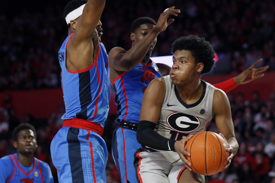 Georgia's Sahvir Wheeler (15) tries to find an open pass around Mississippi guard/forward Blake Hinson (0) and Mississippi guard Bryce Williams (13) during an NCAA college basketball game in Athens, Ga., Saturday, Jan. 25, 2020. (Joshua L. Jones/Athens Banner-Herald via AP)