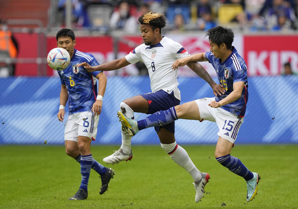 Japan's Daichi Kamada, right, and United States Weston McKennie challenge for the ball during the international friendly soccer match between USA and Japan as part of the Kirin Challenge Cup in Duesseldorf, Germany, Friday, Sept. 23, 2022. (AP Photo/Martin Meissner)