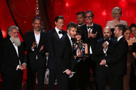 Executive Producers David Benioff (C) and D.B. Weiss (R) accept the award for Oustanding Drama Series for "Game of Thrones" at the 68th Primetime Emmy Awards in Los Angeles, California, U.S., September 18, 2016. REUTERS/Mike Blake