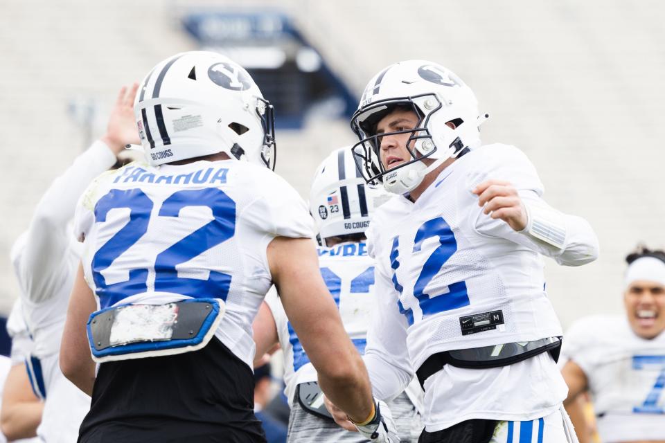 BYU Cougars quarterback Jake Retzlaff (12)&nbsp;celebrates with running back Mason Fakahua (22) during the annual&nbsp;BYU Blue vs. White scrimmage at LaVell Edwards Stadium in Provo on Friday, March 31, 2023.