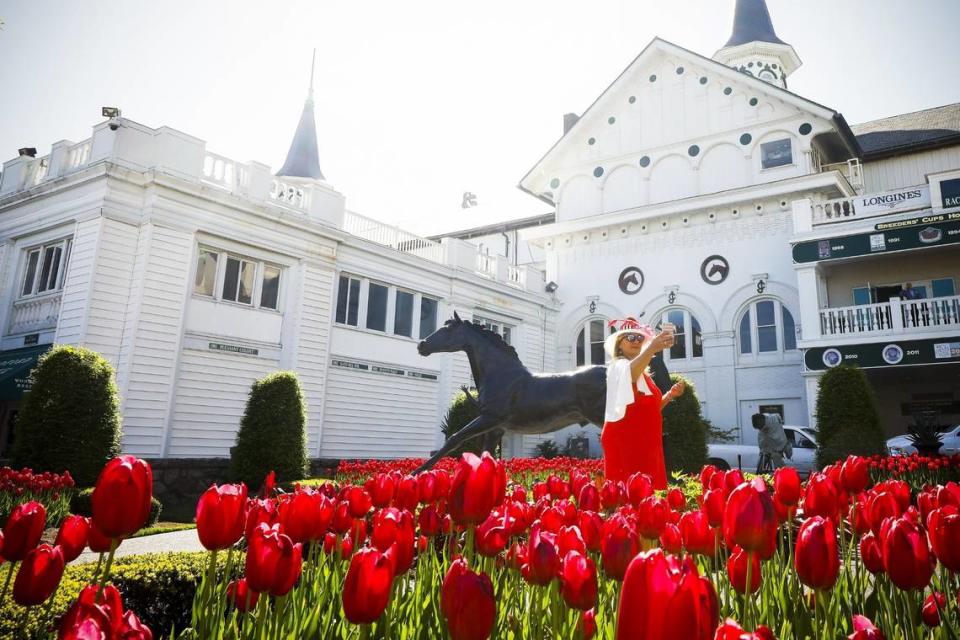 Wendy Hall of Louisville took a selfie with the Aristides statue at Churchill Downs. A crowd limited to 40 to 50 percent of normal capacity will be able to attend Saturday’s Kentucky Derby.