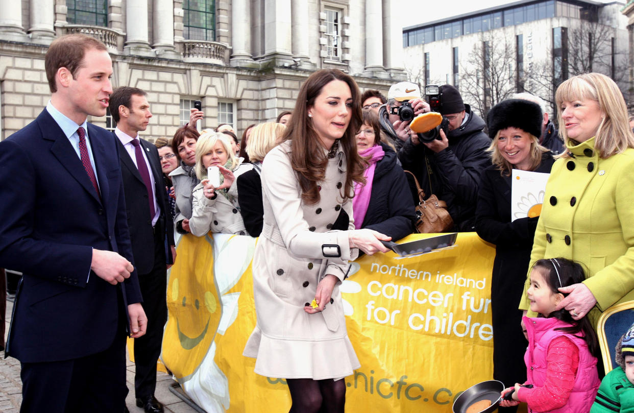 Prince William watches as Kate Middleton flips a pancake during a Northern Ireland Cancer Fund for Children event outside Belfast City Hall, during their visit to Northern Ireland.   (Photo by Paul Faith/PA Images via Getty Images)