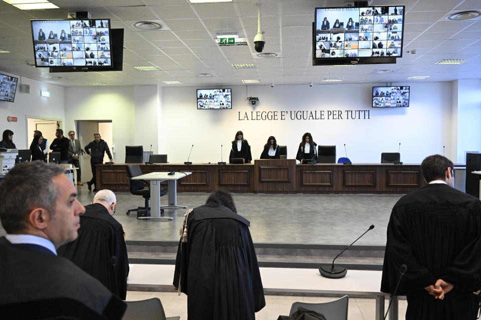 Facing the camera, President of the court Judge Brigida Cavasino, center, flanked by judges Claudia Caputo, left, and Germana Radice reads the sentence of a maxi-trial of hundreds of people accused of membership in Italy's 'ndrangheta organized crime syndicate, one of the world's most powerful, extensive and wealthy drug-trafficking groups, in Lamezia Terme, southern Italy, Monday, Nov. 20, 2023. The trial started almost three years ago in the southern Calabria region, where the mob organization was originally based. (AP Photo/Valeria Ferraro)