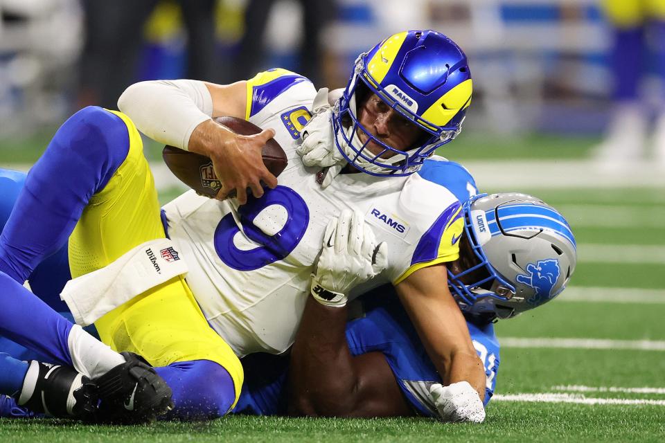 DETROIT, MICHIGAN - SEPTEMBER 08: Matthew Stafford #9 of the Los Angeles Rams is sacked by Levi Onwuzurike #91 of the Detroit Lions in the first quarter at Ford Field on September 08, 2024 in Detroit, Michigan. (Photo by Gregory Shamus/Getty Images)