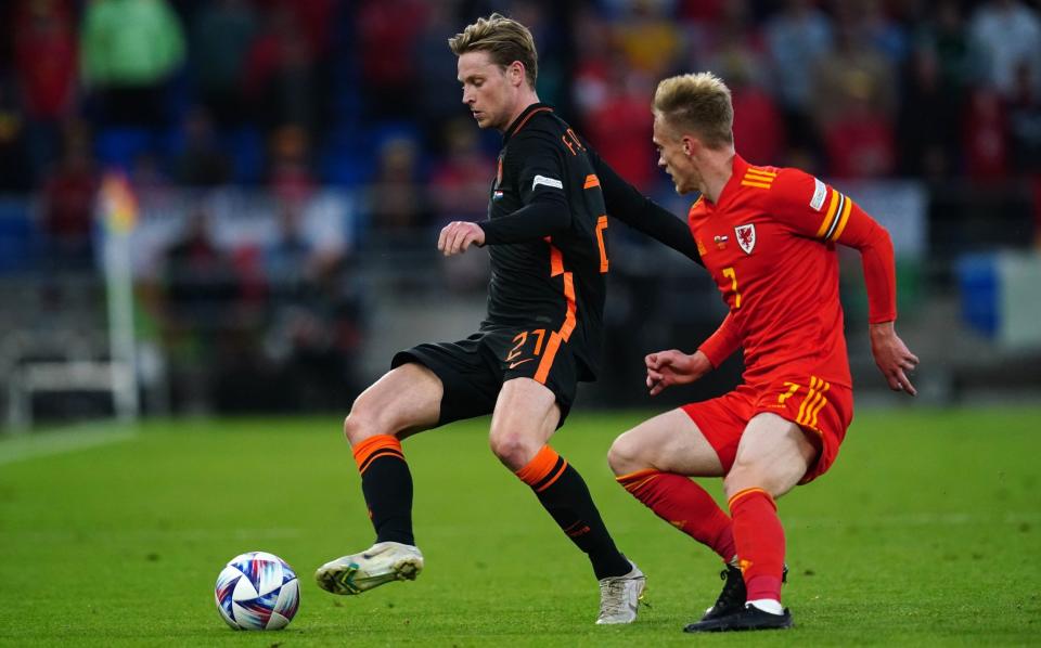 Netherlands' Frenkie de Jong (left) and Wales' Matthew Smith battle for the ball during the Uefa Nations League match at the Cardiff City Stadium - David Davies/PA Wire