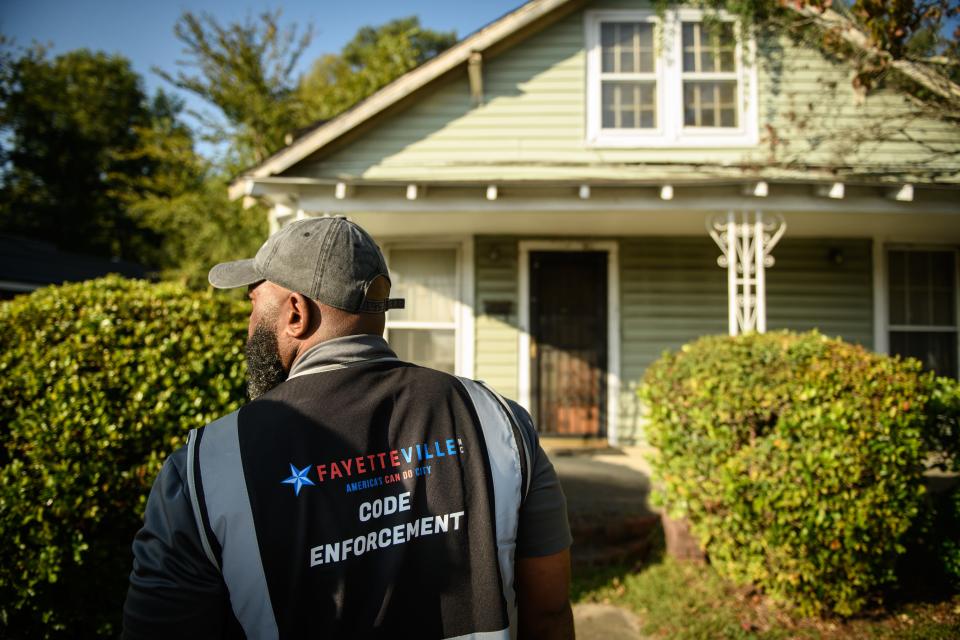 Code enforcement officer Dereke Planter Jr., left, goes over a home on Murchison Road with homeowner Vickie Torrey and contractor Bob Rogers to point out things that need to be done to the home to bring it up to code, Wednesday, Oct. 4, 2023.