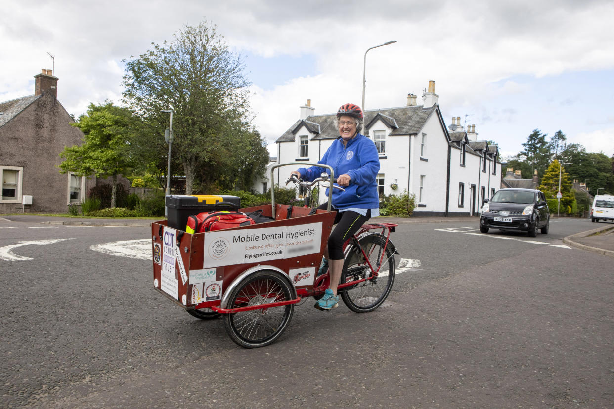 Perry cycles to her next client. (SWNS)