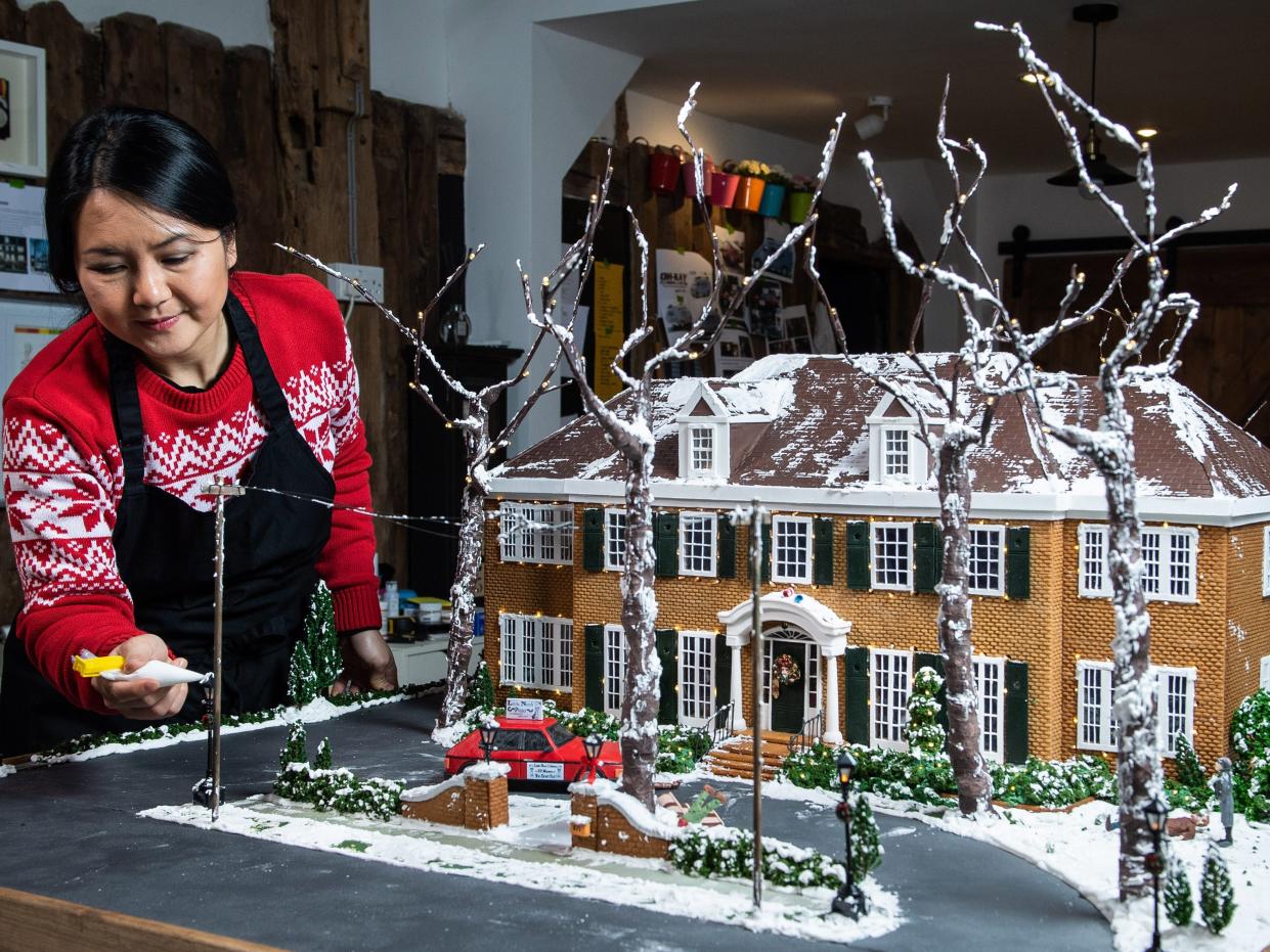 Cake designer Michelle Wibowo works on her gingerbread version of the McCallister house