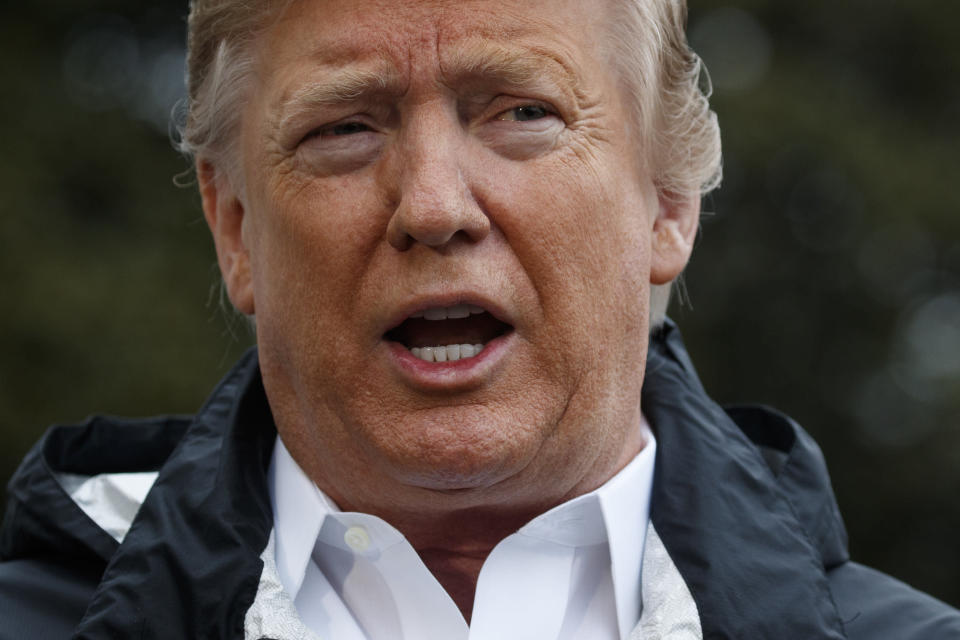 President Trump talks with reporters on the South Lawn of the White House on Friday. (AP Photo/ Evan Vucci)   