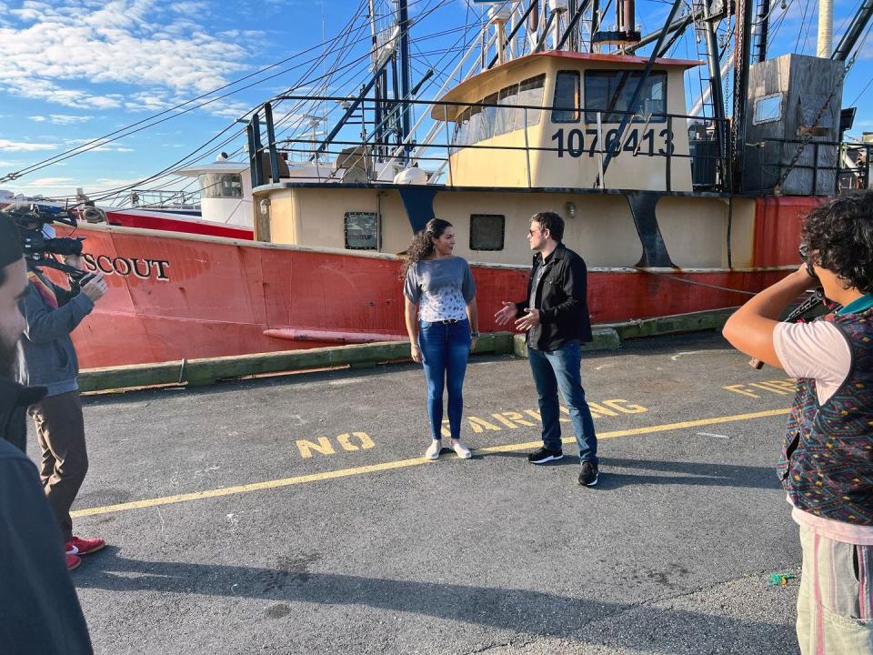 Misha Collins, right, with Cassie Canastra, left, filming an episode of  "Roadfood" at BASE Seafood in New Bedford.