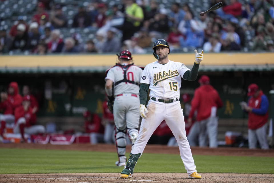 Oakland Athletics' Seth Brown (15) tosses his bat after being called out on strikes during the sixth inning of a baseball game against the Philadelphia Phillies in Oakland, Calif., Friday, June 16, 2023. (AP Photo/Godofredo A. Vásquez)