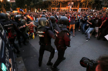 Protestors confront Spanish national police officers who surrounded the leftist Popular Unity Candidacy (CUP) party headquarters in Barcelona, Spain, September 20, 2017. REUTERS/Albert Gea