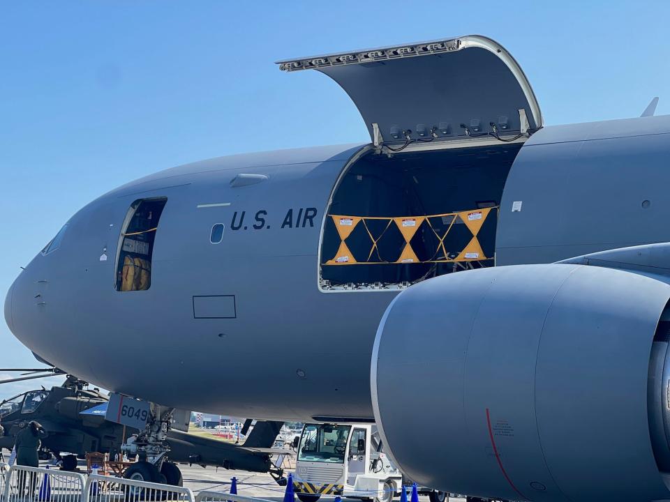 A KC-46 tanker with its side loading door open.