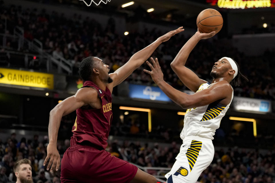 Indiana Pacers center Myles Turner shoots over Cleveland Cavaliers forward Evan Mobley during the second half of an NBA basketball game in Indianapolis, Sunday, Feb. 5, 2023. The Cavaliers won 122-103.(AP Photo/AJ Mast)