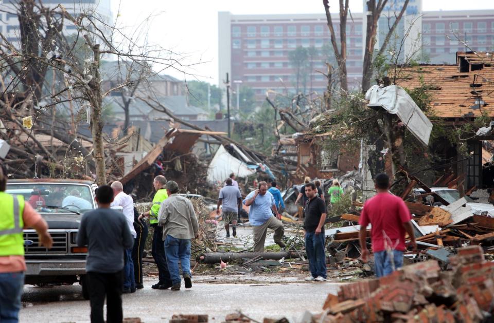 Residents look through debris in the Cedar Crest neighborhood in Tuscaloosa, Ala. Wednesday, April 27, 2011, after a powerful tornado moved through the city.