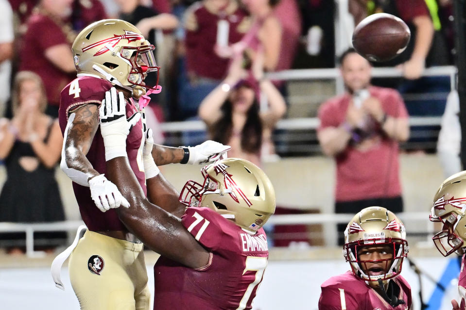 ORLANDO, FLORIDA - SEPTEMBER 03: Keon Coleman #4 of the Florida State Seminoles celebrates with teammate D'Mitri Emmanuel #71 after scoring in the first quarter against the LSU Tigers at Camping World Stadium on September 03, 2023 in Orlando, Florida. (Photo by Julio Aguilar/Getty Images)