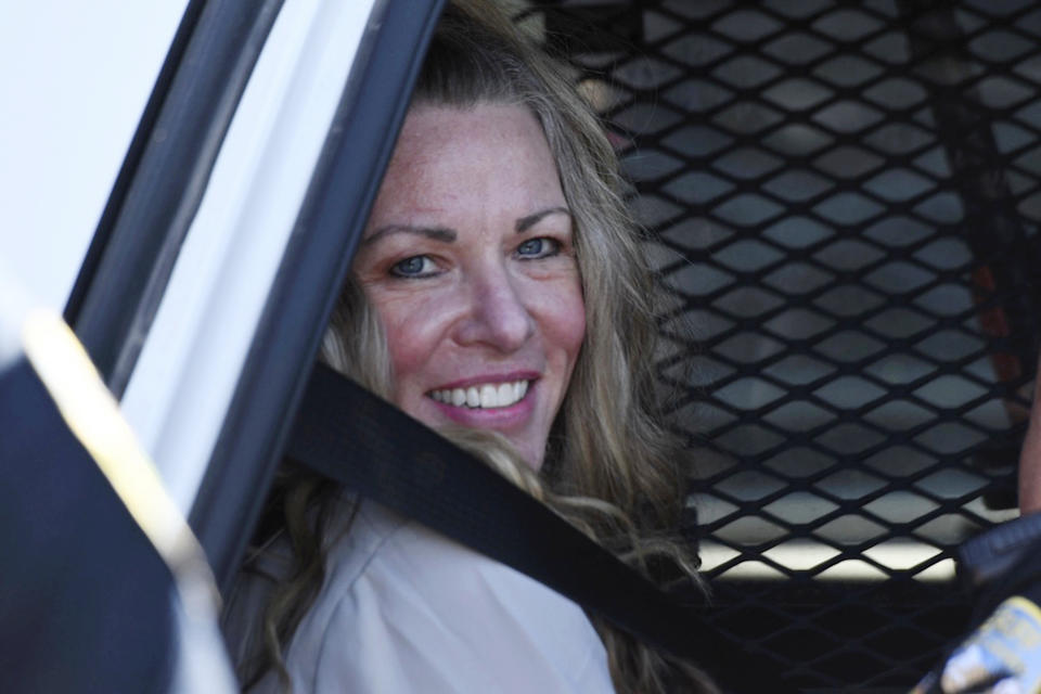FILE - Lori Vallow Daybell sits in a police car after a hearing at the Fremont County Courthouse in St. Anthony, Idaho, on Aug. 16, 2022. A mother charged with murder in the deaths of her two children is set to stand trial in Idaho. The proceedings against Lori Vallow Daybell beginning Monday, April 3, 2023, could reveal new details in the strange, doomsday-focused case. (Tony Blakeslee/East Idaho News via AP, Pool, File)