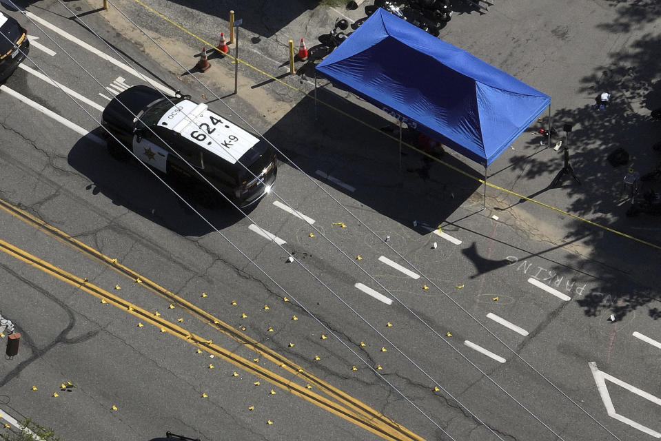 This aerial view shows markings on the street in front of Cook's Corner, Thursday, Aug. 24, 2023, in Trabuco Canyon, Calif. Gunfire at a popular Southern California biker bar killed three people and wounded five others, and the gunman — believed to be a retired law enforcement officer — was fatally shot by deputies, authorities said. (AP Photo/Jae C. Hong)