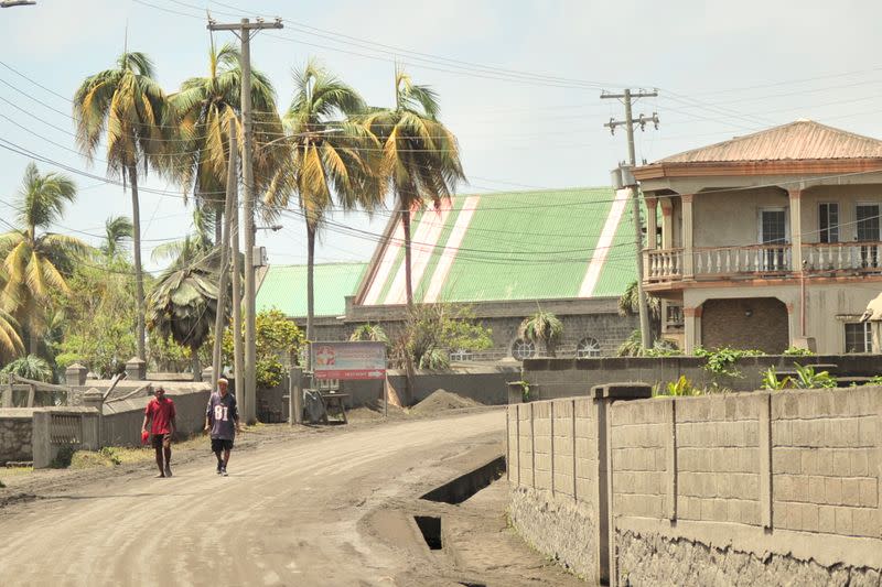 Men walk down a street after a series of eruptions from La Soufriere volcano