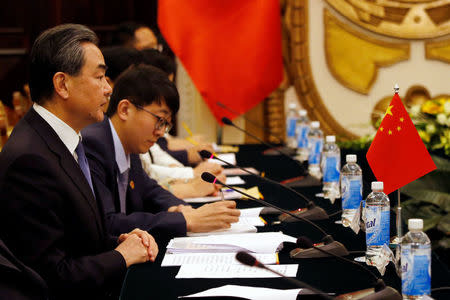 China's State Councilor and Foreign Minister Wang Yi (L) is seen during a talk with Vietnam's Deputy Prime Minister and Foreign Minister Pham Binh Minh (not pictured) at the Government Guesthouse in Hanoi, Vietnam April 1, 2018. REUTERS/Kham