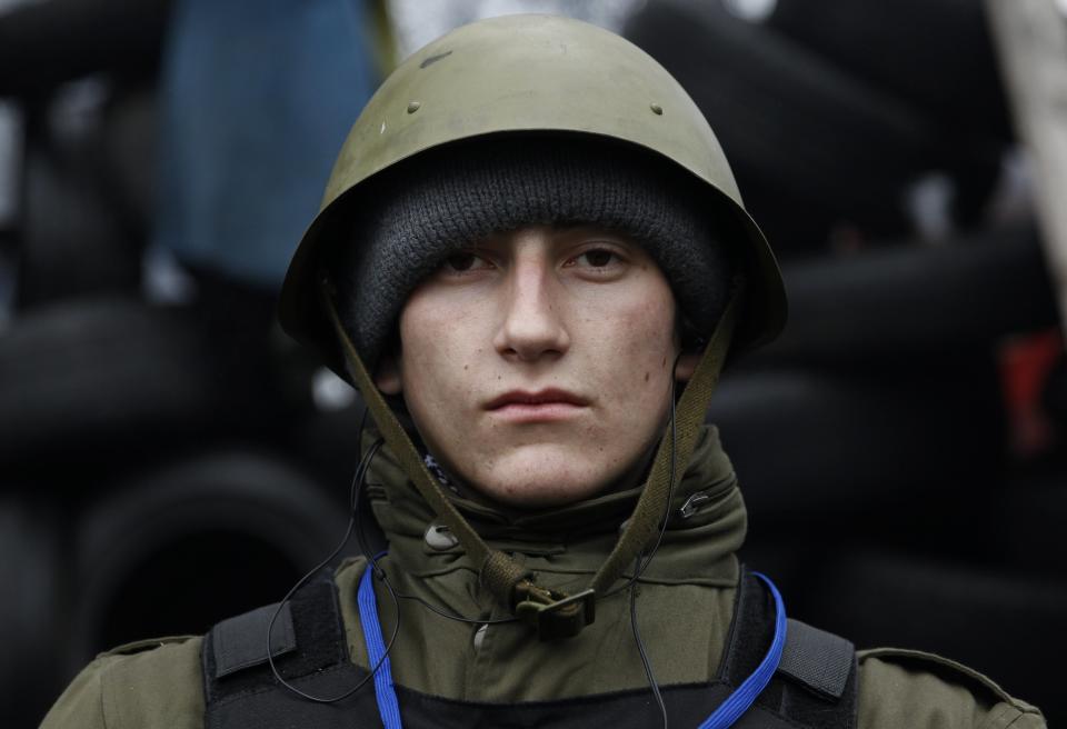 Anatoli, a 19-year-old student from the town of Dnepropetrovsk, poses for a picture at the barricades in Kiev