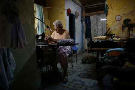 Retired school teacher Magali Alonso sews at home in downtown Havana, Cuba, July 8, 2016. REUTERS/Alexandre Meneghini