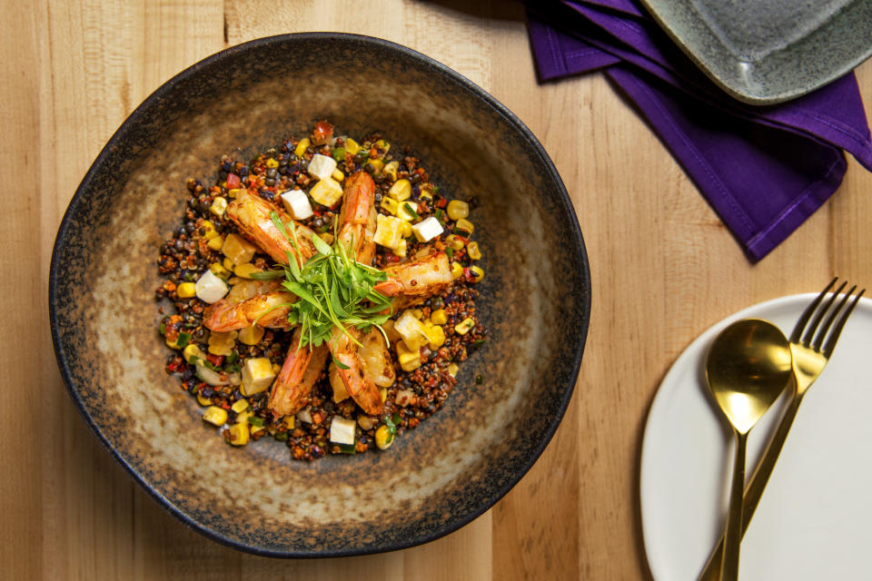 Chica's &ldquo;Grilled Shrimp and Quinoa&rdquo; with beluga lentils, queso fresco, fire-roasted corn, chile poblano and purple potato sofrito. (Photo: Chica)