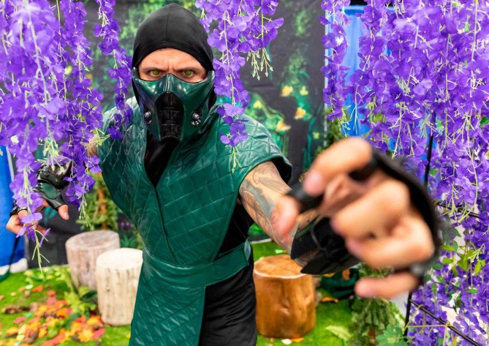 Adrian Suarez, 35, cosplays as Reptile from Mortal Kombat during Florida Supercon 2023 on Friday, June 30, 2023, in Miami Beach, Fla. Fernandez is the Emerald Herald and Taggart is the player character.