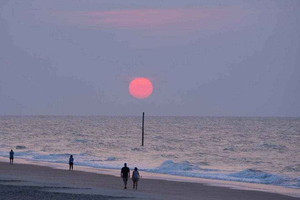 People walking along the beach at sunset on Ocracoke