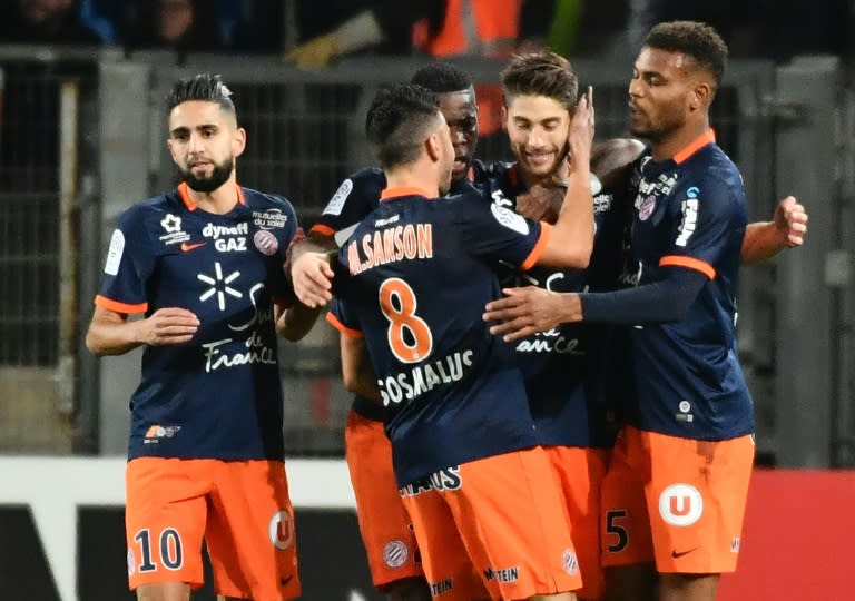 Montpellier's French midfielder Paul Lasne (2ndR) is congratuled by teammates after scoring a goal against Paris Saint Germaino on December 3, 2016 at the La Mosson Stadium in Montpellier, southern France