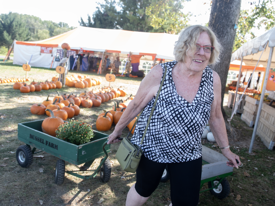 Kathy Zaryki of Brimfield buys pumpkins and mums at Dussel Farm on Oct. 3.