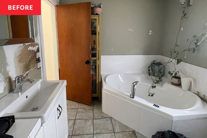 Gray bathroom with white cabinets and gray tile floor before makeover