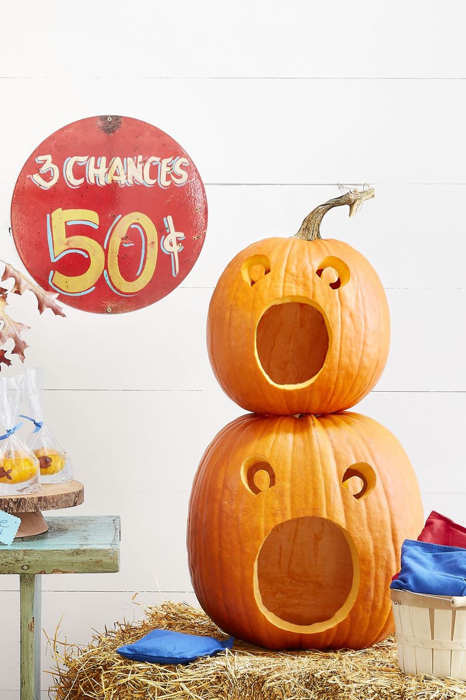 <p>This year, get two spooky season activities for the price of one: <a href="https://www.goodhousekeeping.com/holidays/halloween-ideas/g238/pumpkin-carving-ideas/" rel="nofollow noopener" target="_blank" data-ylk="slk:carve your pumpkins;elm:context_link;itc:0;sec:content-canvas" class="link ">carve your pumpkins</a> into a fun bean-bag toss. To make this game, cut a large hole in the bottom of one large and one medium pumpkin and scoop out the pulp and seeds.</p><p> Trace this <a href="https://hmg-prod.s3.amazonaws.com/files/pumpkin-carving-template-beanbag-toss-1018-1536169820.pdf?tag=syn-yahoo-20&ascsubtag=%5Bartid%7C10055.g.2618%5Bsrc%7Cyahoo-us" rel="nofollow noopener" target="_blank" data-ylk="slk:face template;elm:context_link;itc:0;sec:content-canvas" class="link ">face template</a> onto the pumpkins, scaling up or down as necessary. Cut out the faces, and then stack the medium pumpkin on top of the large one, using skewers to help hold them in place. To play, toss beanbags into the pumpkins' mouths and award 10 points for the bottom gourd and 20 for the top. </p>