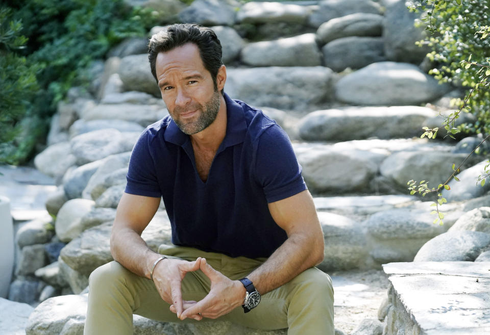 Actor and voiceover artist Chris Diamantopoulos poses for a portrait at his home in Los Angeles on Nov. 5, 2021. Diamantopoulos stars in the Netflix film "Red Notice." (AP Photo/Chris Pizzello)