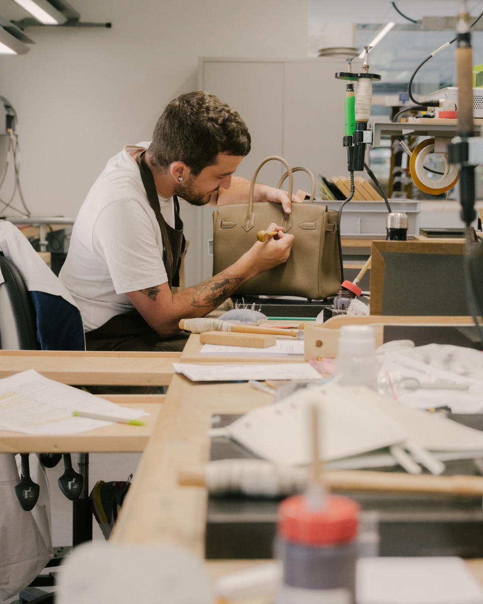 A craftsman working on a Birkin bag inside the new Hermès facility in Saint Junien, France.