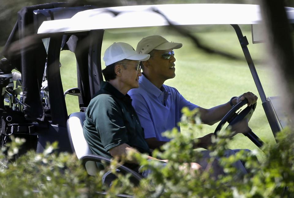 President Barack Obama drives a golf cart with World Bank President Jim Kim during a golf outing at Vineyard Golf Club in Edgartown, Mass., on the island of Martha's Vineyard Wednesday, Aug. 14, 2013. (AP Photo/Steven Senne)