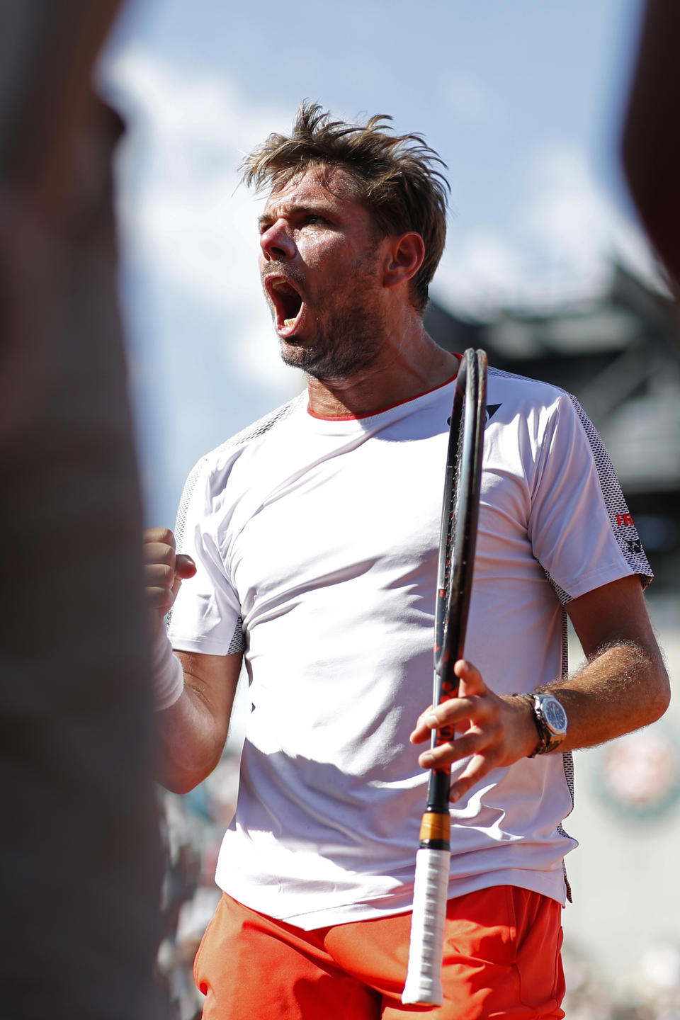 Switzerland's Stan Wawrinka screams after scoring a point against Greece's Stefanos Tsitsipas during their fourth round match of the French Open tennis tournament at the Roland Garros stadium in Paris, Sunday, June 2, 2019. (AP Photo/Christophe Ena )