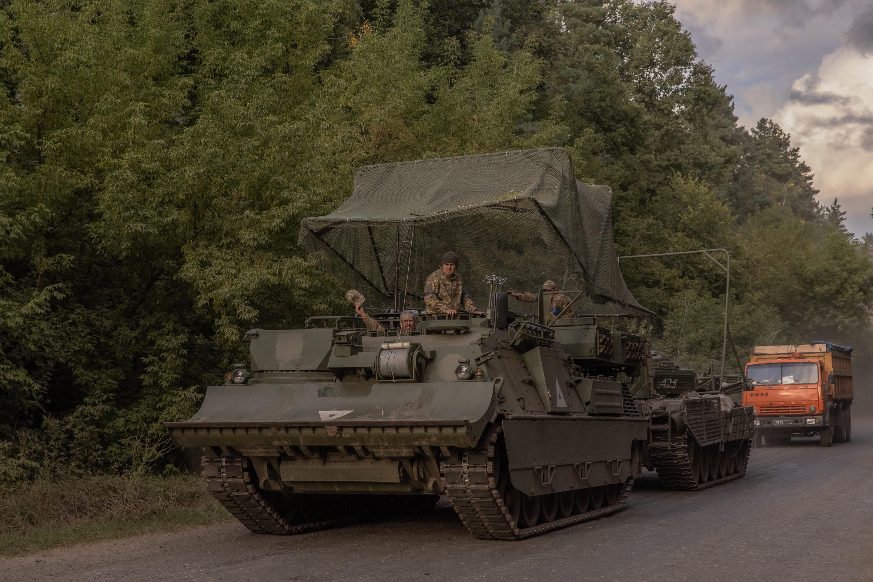 Ukrainian servicemen operate an armored military vehicle. 