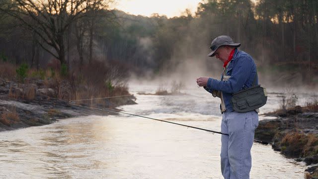 <p>courtesy netflix</p> Dennis Shepard works with his fishing tackle before casting it out to the river.