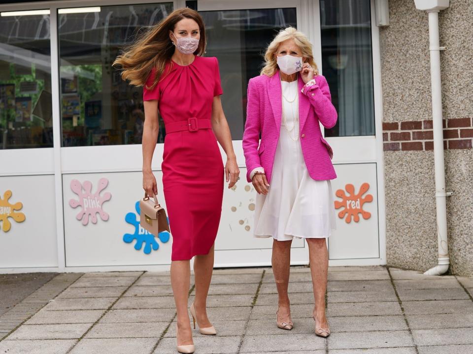 Kate Middleton and Jill Biden walk in front of a school together.