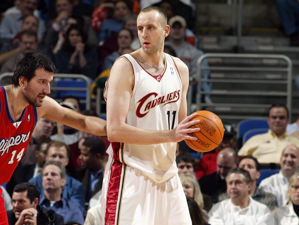 Zydrunas Ilgauskas holds the ball with his back to the basket during a game in 2003.