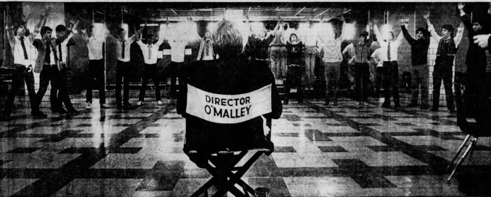 Rev. William J. O'Malley directing a student musical, 1983