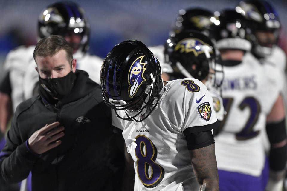 Baltimore Ravens quarterback Lamar Jackson (8) is helped off the field after he was injured during the second half of an NFL divisional round football game against the Buffalo Bills Saturday, Jan. 16, 2021, in Orchard Park, N.Y. (AP Photo/Adrian Kraus)