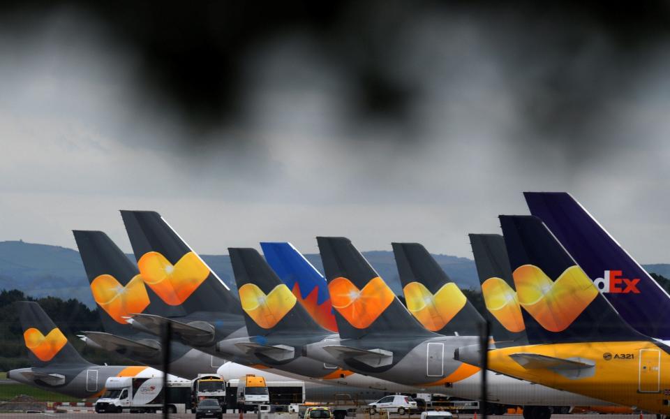 Thomas Cook passenger aircraft parked on tarmac at Manchester Airport - AFP