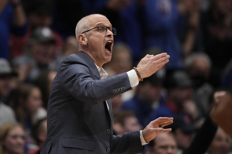 UConn head coach Dan Hurley talks to his players during the first half of an NCAA college basketball against Kansas game Friday, Dec. 1, 2023, in Lawrence, Kan. (AP Photo/Charlie Riedel)