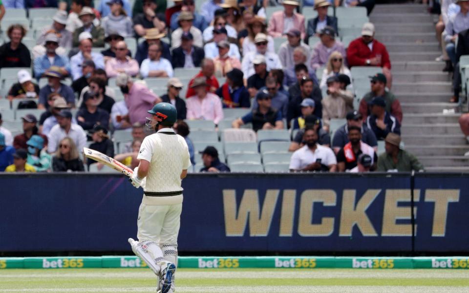 Travis Head walks off after losing his wicket - REUTERS