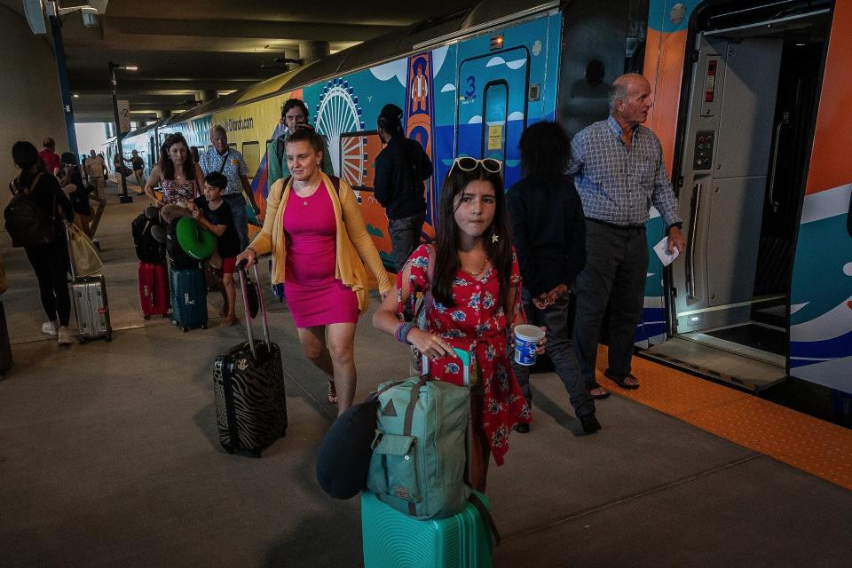 Passengers arrive in Orlando aboard the Brightline train from West Palm Beach, Fla., on September 22, 2023.