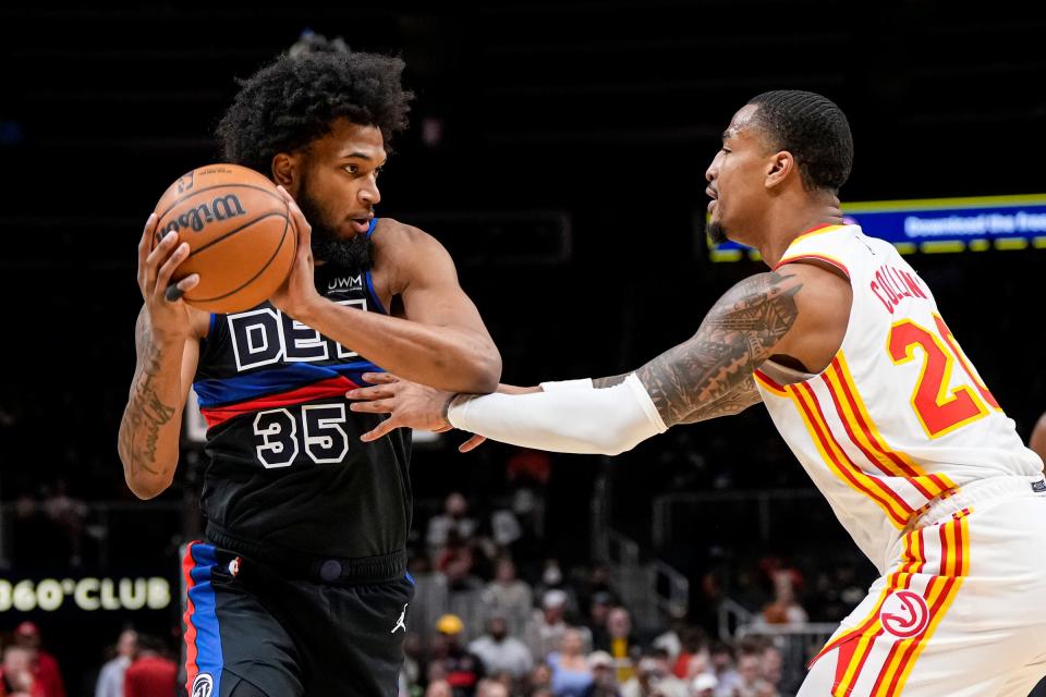 Detroit Pistons forward Marvin Bagley III (35) is defended by Atlanta Hawks forward John Collins (20) during the first half at State Farm Arena in Atlanta on Tuesday, March 21, 2023.